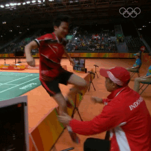 a man in a red jacket with the word indonesia on the back