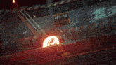 a person is laying on the ground in front of a large fireball with the number 2 in the background