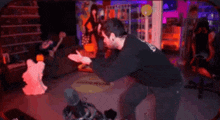 a man is dancing in front of a microphone in a room with a ghost .