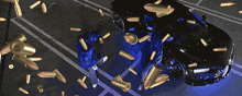 a car is surrounded by bullets and a group of people are standing around it
