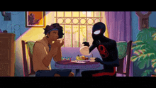 a man and a spiderman are sitting at a table with a sign that says what on it
