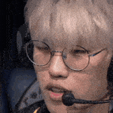 a close up of a person wearing glasses and a headset with a microphone