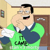 a man in a green shirt that says " it came stan < 3 morty "