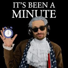 a man wearing a wig and sunglasses holds up an alarm clock with the words it 's been a minute above