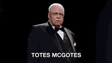 a man in a tuxedo says totes mcgotes in white letters