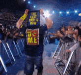 a wrestler is holding a sign that says the last time is now .