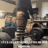 a person in striped socks is lifting a barbell with the words yüce gece valorant da merti pasiyor