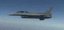 a fighter jet is flying in the sky and has the letters lm on the tail