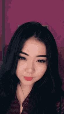 a close up of a girl 's face with a pink background