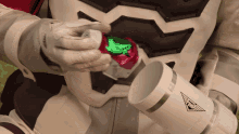 a person in a space suit is holding a cup with a logo that says tmc