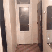 a hallway with a door and a mirror in it