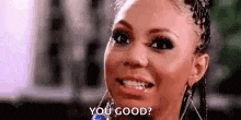 a close up of a woman 's face with the words `` you good '' written on it .
