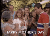 a group of people are celebrating mother 's day with a man and a woman dancing .