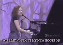 a woman is singing into a microphone while playing a piano .