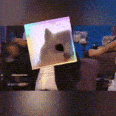 a person is holding a box with a picture of a cat on it .