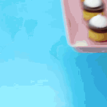 three cupcakes with whipped cream on top of them on a white plate