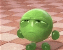 a green cartoon character is walking on a checkered floor .