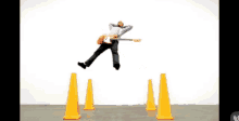 a man is jumping in the air with a guitar
