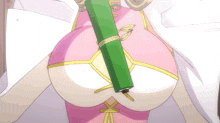 a woman in a pink dress is holding a green object in her hand