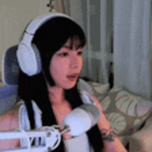 a woman is wearing headphones and holding a microphone .