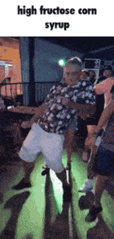 a man is dancing on a dance floor with a caption that says high fructose corn syrup .