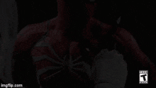a close up of a spiderman 's chest with a t on the bottom