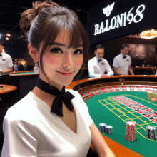 a woman playing roulette in front of a sign that says ballon168