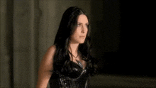 a woman with long black hair and a black corset