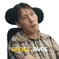 a man in a plaid shirt is sitting in a chair with the words gross dude written on the bottom