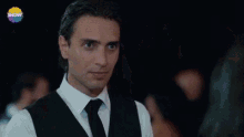 a man and two women are dancing in a room with tables and a sign that says show