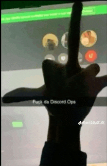 a person is giving the middle finger in front of a screen .