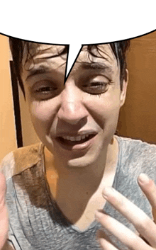 a man is making a funny face with a speech bubble around his head .