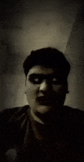 a close up of a man 's face with his mouth open and his eyes glowing