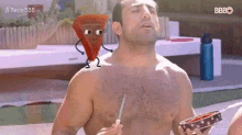 a shirtless man is standing next to a pizza with arms and legs on his chest .