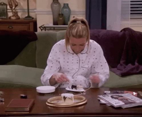Phoebe from Friends smashes her beeping smoke alarm with a shoe.