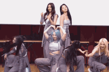a girl with blue hair is making a heart with her hands