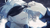 a man with white hair and blue eyes is wearing a blindfold over his eyes