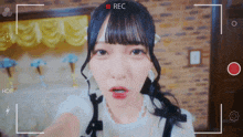 a girl is being recorded with a red rec button in the corner