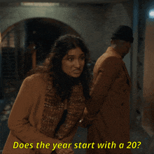 a man and a woman are standing next to each other and the woman is asking if the year starts with a 20