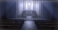 a church with rows of pews and an altar with a cross on it