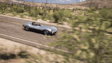 a car is driving down a road in the desert
