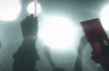 a blurry picture of a person holding a red light