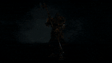 a knight in armor is holding a large axe in his hand .