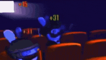 a bunch of stuffed animals are sitting in a theater .