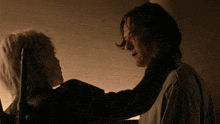 a man and a woman looking at each other in the dark