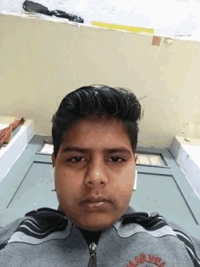 a young boy wearing a sweatshirt that says nike on it