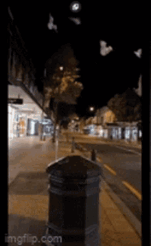 a picture of a street at night with a watermark that says imgflip.com on it