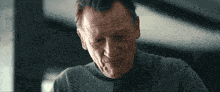 a close up of an older man 's face looking down