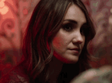 a close up of a woman 's face in a dark room