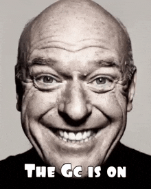 a black and white photo of an older man smiling with the caption the gc is on .